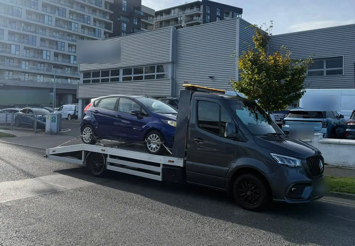 Our grey truck on a Dublin street beside apartment blocks and offices